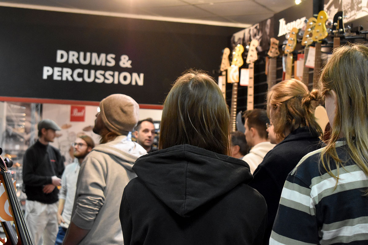 Schülerinnen und Schüler der Berufsschule Mittenwald vor der Drum- und Percussion-Abteilung im Musikhaus Kirstein