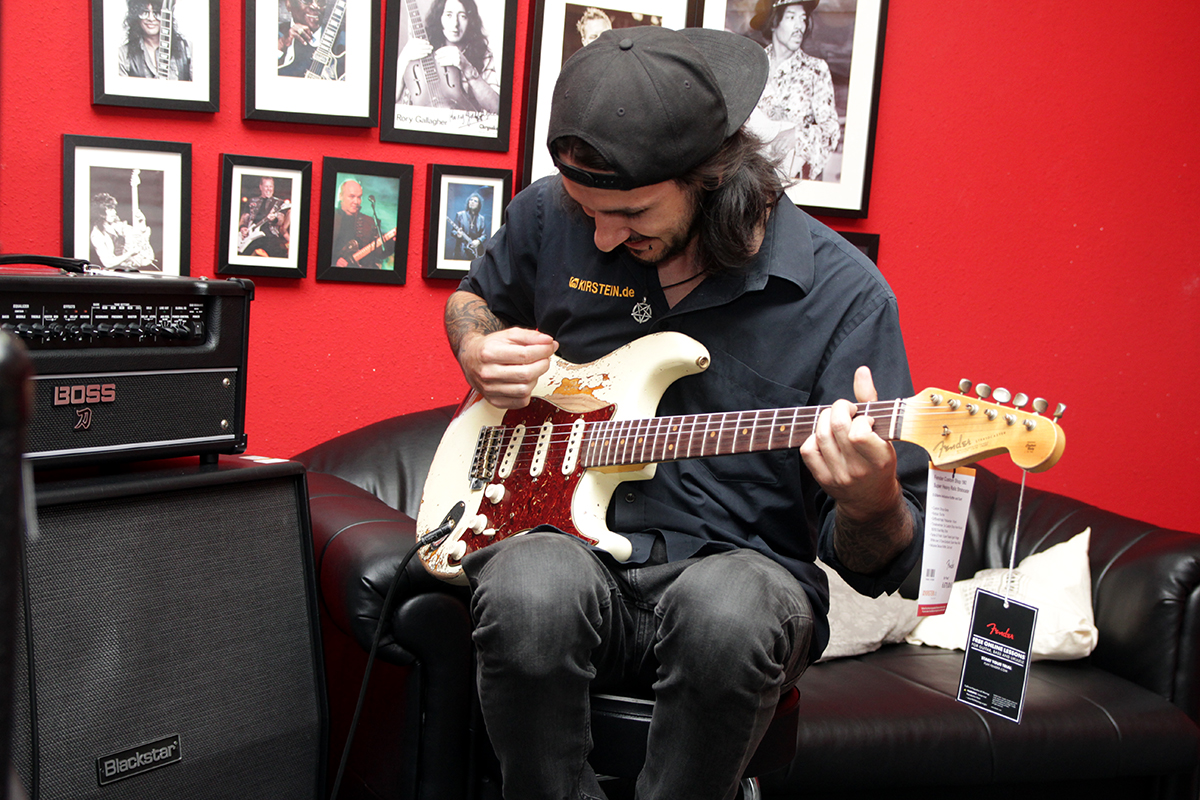 Kirstein-Mitarbeiter Max beim Spielen einer E-Gitarre